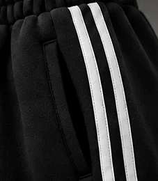 Black: Contrast double stripes along each leg.