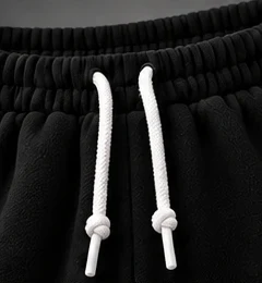 Black: An elastic waistband with adjustable drawcords.